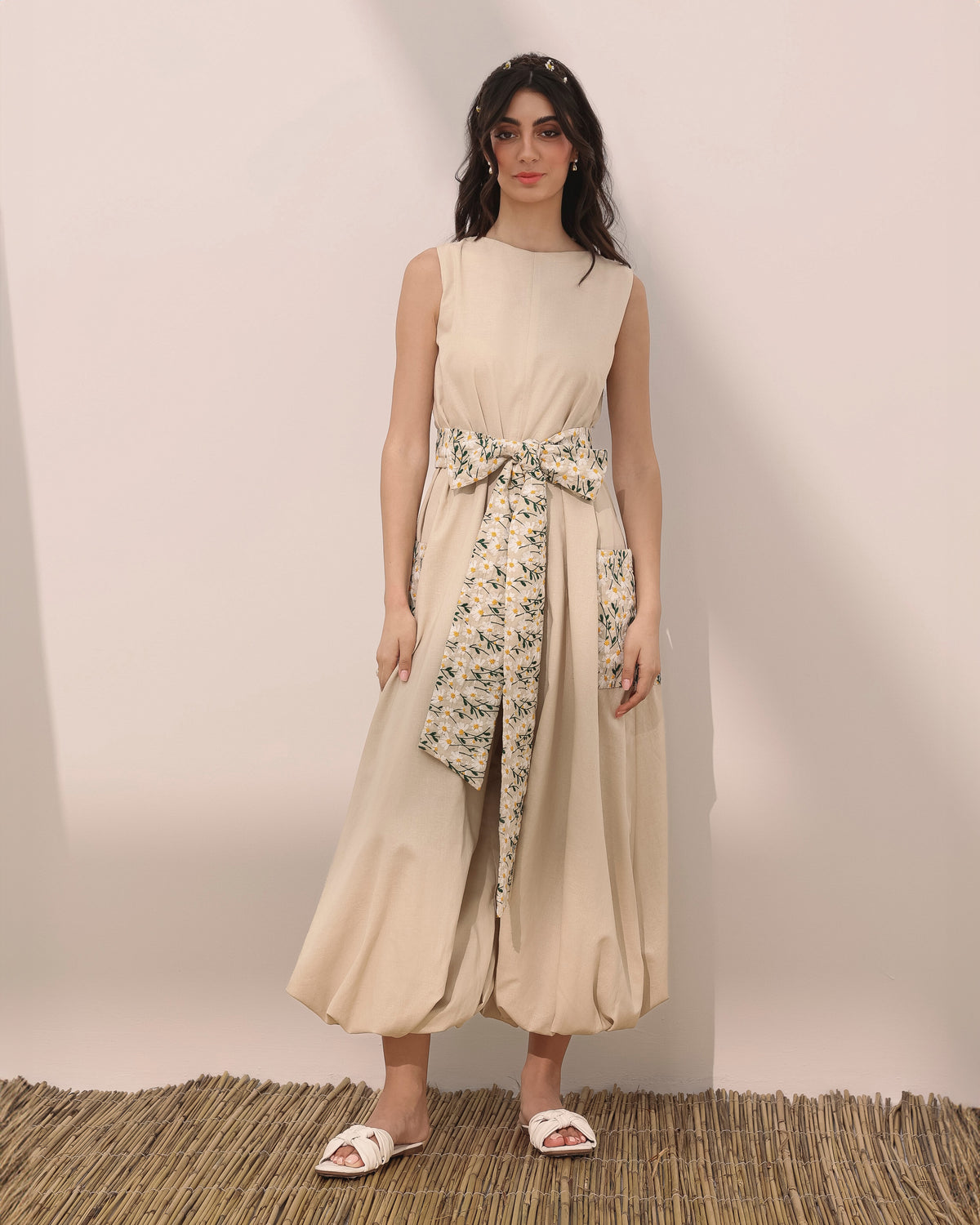 Sleeveless linen balloon jumpsuit w/ embroidered daisy flowers on pockets and belt