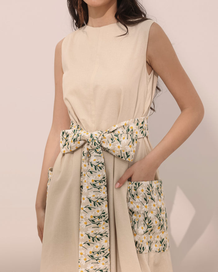 Sleeveless linen balloon jumpsuit w/ embroidered daisy flowers on pockets and belt