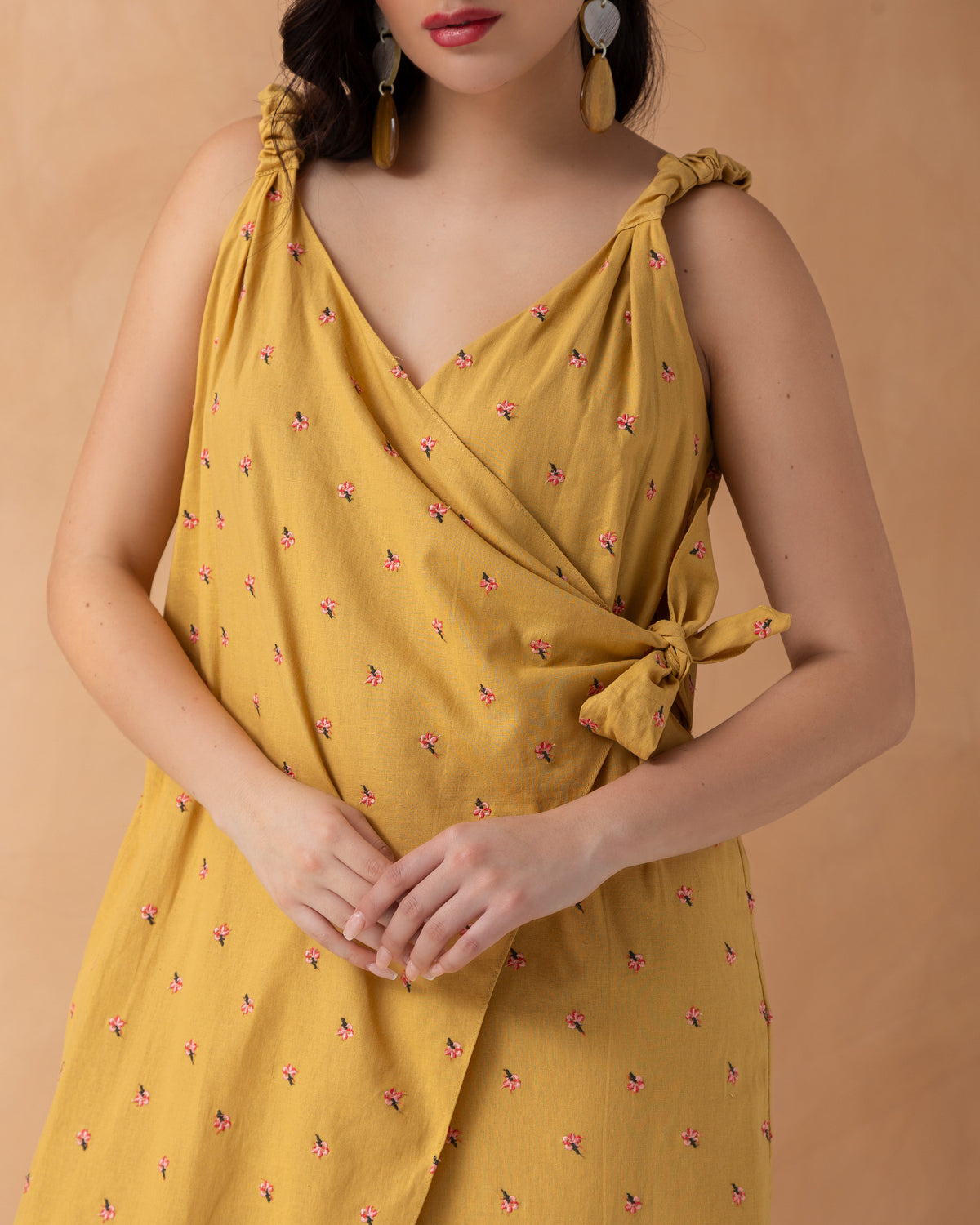 Sleeveless overlapped cotton jumpsuit with mini embroidered flowers
